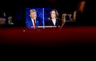 Former President Donald Trump and Vice President Kamala Harris are shown on screen in the spin room during the second presidential debate at the Pennsylvania Convention Center in Philadelphia, Pennsylvania, US, on Tuesday, Sept. 10, 2024. 