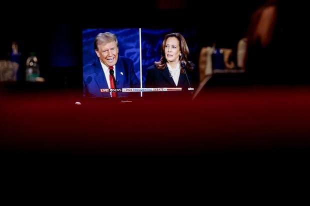 Former President Donald Trump and Vice President Kamala Harris are shown on screen in the spin room during the second presidential debate at the Pennsylvania Convention Center in Philadelphia, Pennsylvania, US, on Tuesday, Sept. 10, 2024.
