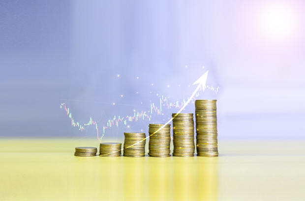 Gold coins chart an increase inflation.financial graph showing inflation concept. Displays stock market statistics, crises, inflation, electronic charts with stock market volatility. abstract concep 