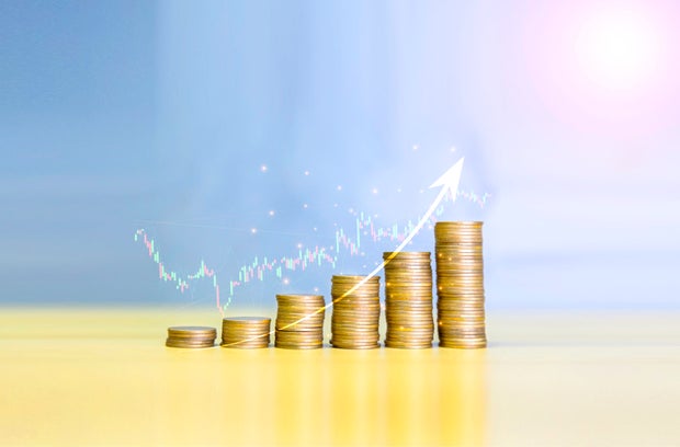 Gold coins chart an increase inflation.financial graph showing inflation concept. Displays stock market statistics, crises, inflation, electronic charts with stock market volatility. abstract concep