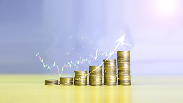 Gold coins chart an increase inflation.financial graph showing inflation concept. Displays stock market statistics, crises, inflation, electronic charts with stock market volatility. abstract concep 