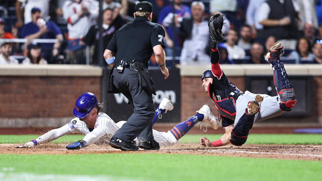 Brandon Nimmo #9 of the New York Mets scores ahead of the tag by Drew Millas #81 of the Washington Nationals during the fourth inning of the game at Citi Field on September 18, 2024 in New York City. 