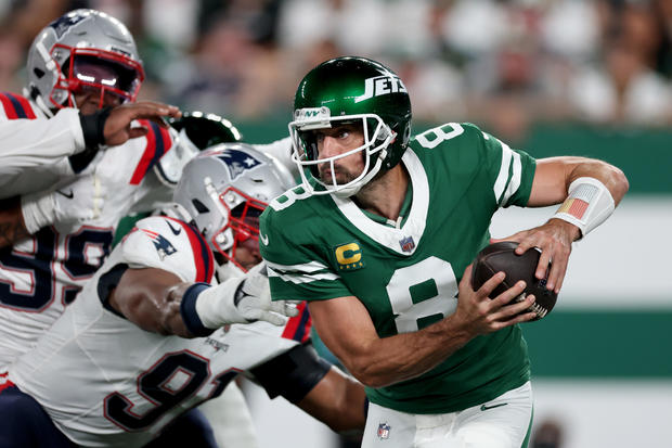 Aaron Rodgers #8 of the New York Jets scrambles against the New England Patriots during the second quarter in the game at MetLife Stadium on September 19, 2024 in East Rutherford, New Jersey. 