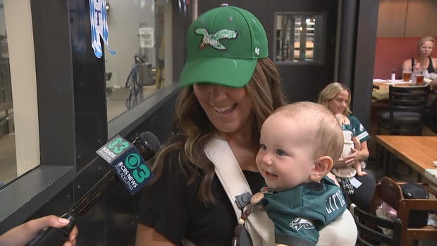 Molly Bradley holds her son, Leo, who is wearing an Eagles jersey 