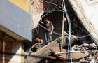 People gather near the site of an Israeli strike in Beirut's southern suburbs 