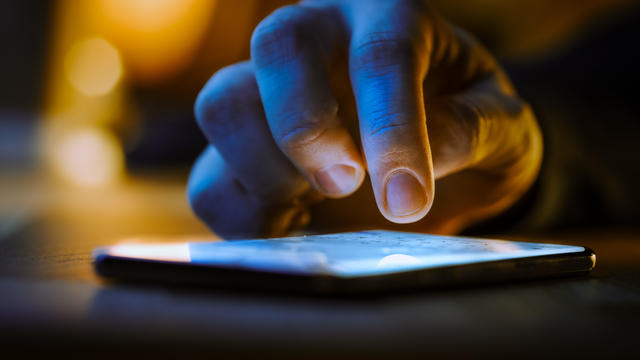 Touch Screen Smartphone Lying on the Table while Person is Typing a Message. Concept of Email Writing, Chatting in Social Media Apps, Sending an SMS, Taking Note. Close-up Macro View 