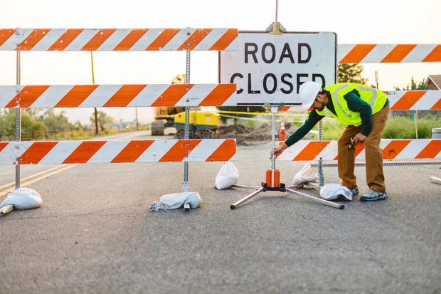 Hispanic Workers Setting Barriers and Directing Traffic Street Road and Highway Construction Photo Series 