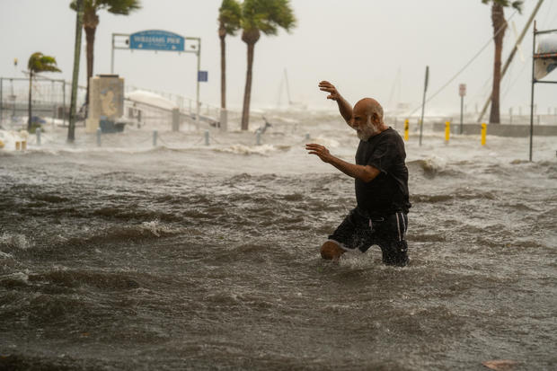 Business City News A man crosses a storm surge flooded area on the coast of Gulfport, Florida, as Hurricane Helene passed through the Gulf of Mexico to the west on Sept. 26, 2024. 