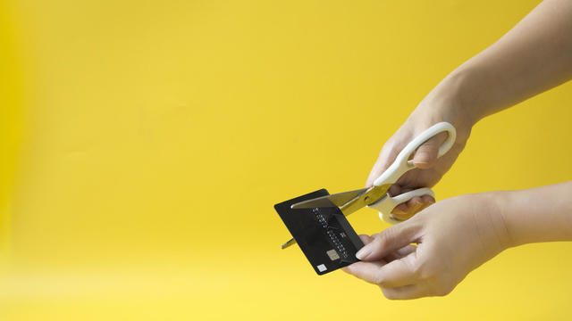 Hand cutting credit card - stock photo. 