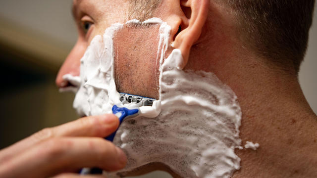 Man shaving with razor 