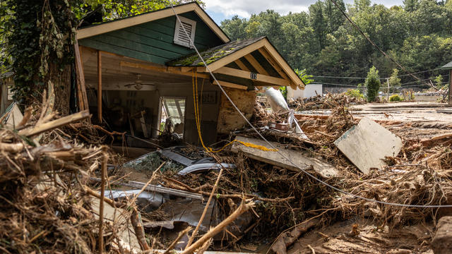 A destroyed house with a car under it is seen in Chimney Rock, North Carolina, Sept. 29, 2024. 