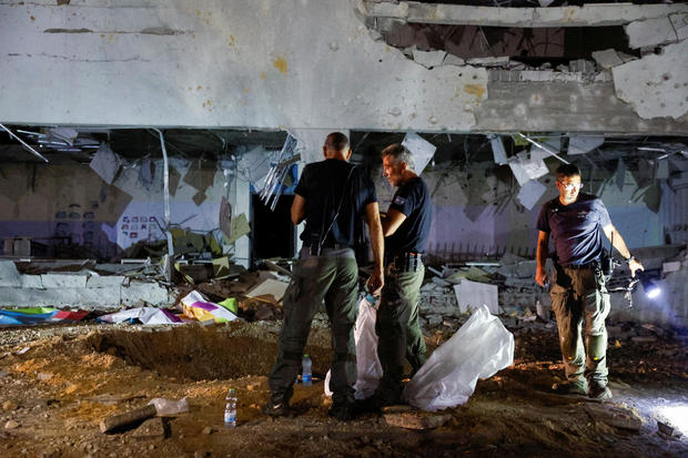 Israeli rescue force secures the site where a missile fired from Iran towards Israel hit a school building in central Israel 