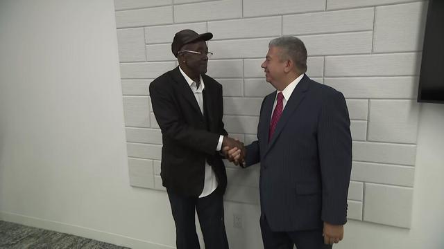 Keith Roberts shakes hands with Brooklyn District Attorney Eric Gonzalez. 