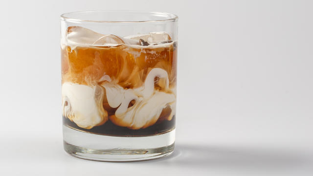 Alcoholic coffee creamy cocktail in glass glass on white background 