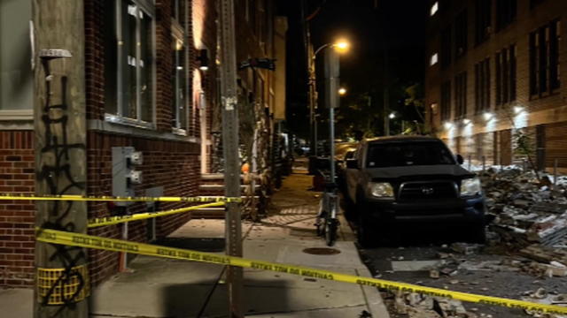 Caution tape is seen near a building that partially collapsed 