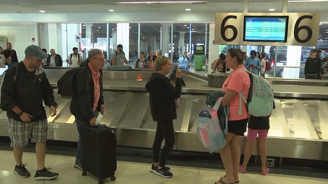 Travelers grab their bags from the baggage control at Philadelphia International Airport 