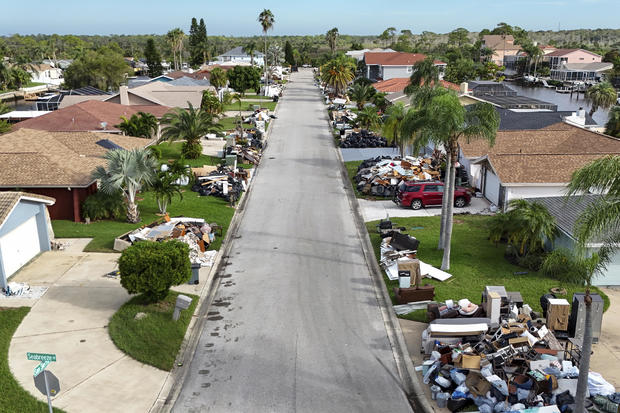 Debris from homes flooded by Hurricane Helene sits curbside as Hurricane Milton approaches on Oct. 8, 2024, in Port Richey, Florida. 