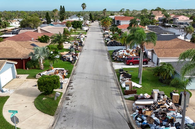 Debris from homes flooded by Hurricane Helene sits curbside as Hurricane Milton approaches on Oct. 8, 2024, in Port Richey, Florida.