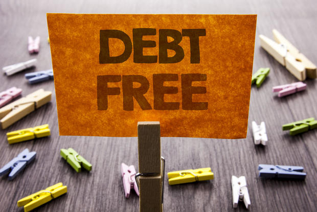 Handwritten text sign showing Debt Free. Business concept for Credit Money Financial Sign Freedom From Loan Mortage written on sticky Note on the wooden background. 