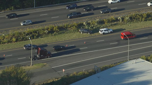 An overhead shot of I-95, where a police vehicle is seen on the side of the road, along with a black car that was involved in a crash 