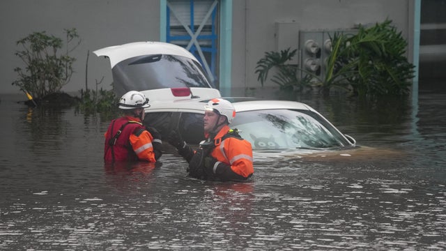 First responders are seen in the water outside an apartment complex that was flooded from an overflowing creek due to Hurricane Milton on Oct. 10, 2024, in Clearwater, Florida. 