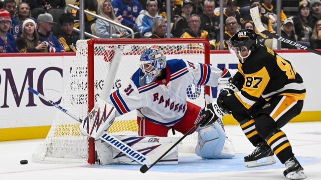 New York Rangers goaltender Igor Shesterkin (31) makes a save on Pittsburgh Penguins center Sidney Crosby (87) in front during the second period in the NHL game between the Pittsburgh Penguins and the New York Rangers on October 9, 2024, at PPG Paints Are 