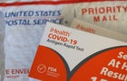 A woman using Covid-19 rapid self-test kit at home 