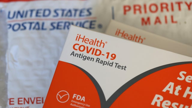 A woman using Covid-19 rapid self-test kit at home 