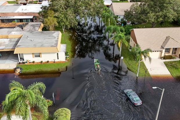 A member of the Pasco County Sheriff's Office goes out to help residents trapped in their homes as waters rise after Hurricane Milton caused the Anclote River to flood, Oct. 11, 2024, in New Port Richey, Florida.