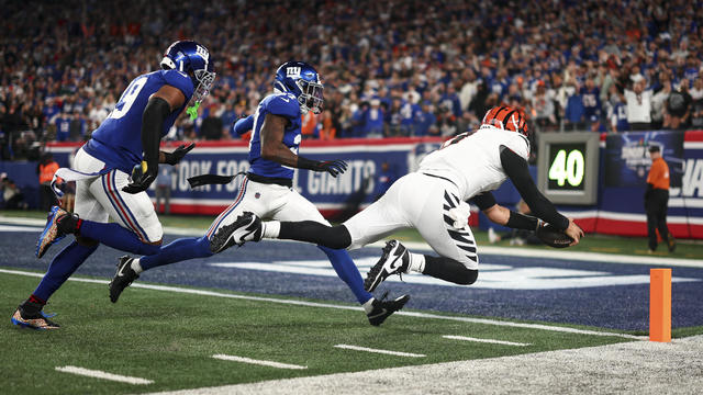 Joe Burrow #9 of the Cincinnati Bengals dives to score a touchdown during the first half of an NFL game against the New York Giants at MetLife Stadium on October 13, 2024 in East Rutherford, New Jersey. 