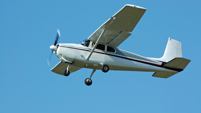 private airplane Cessna 182 flying in clear blue sky 