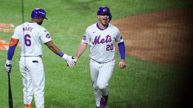 Pete Alonso #20 of the New York Mets celebrates with Starling Marte #6 after scoring on a triple hit by Jesse Winker #3 in the fourth inning during Game 5 of the NLCS presented by loanDepot between the Los Angeles Dodgers and the New York Mets at Citi Field on Friday, October 18, 2024 in New York, New York. 