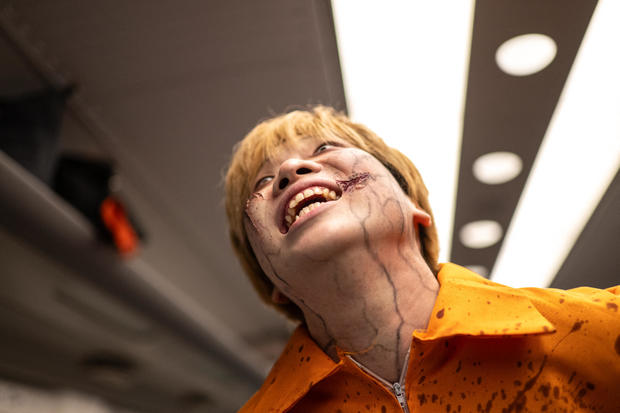 An actor performer for passengers during the 'Zombie Shinkansen' event on a bullet train from Tokyo to Osaka, ahead of Halloween