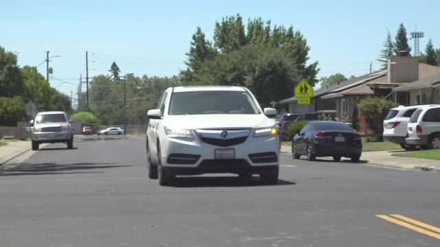 car-driving-down-residential-road.jpg 