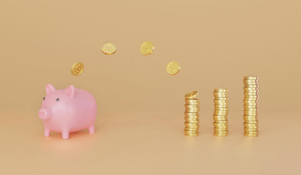 Pink piggy bank with many gold coins stacked beside the bank on golden background. 3D rendering 