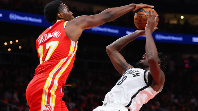 Onyeka Okongwu #17 of the Atlanta Hawks blocks a shot by Dorian Finney-Smith #28 of the Brooklyn Nets during the second quarter at State Farm Arena on October 23, 2024 in Atlanta, Georgia. 