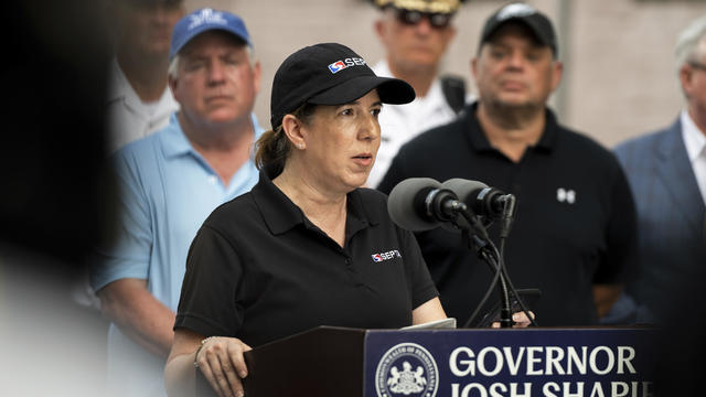 Leslie Richards wearing a SEPTA hat, speaking during a news conference, the podium says Governor Josh Shapiro 