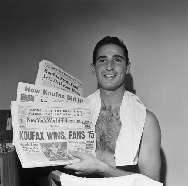 Sandy Koufax Holds 1963 Newspapers Headlining World Series 