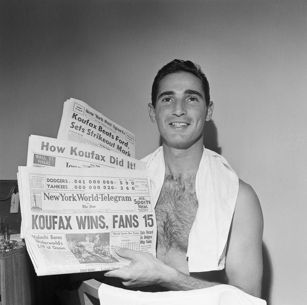 Sandy Koufax Holds 1963 Newspapers Headlining World Series