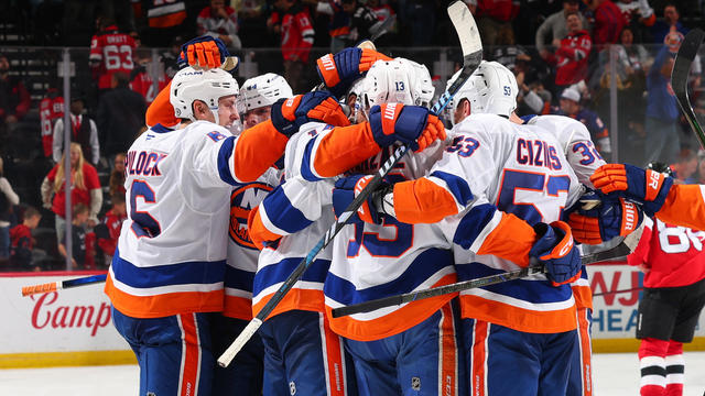 Bo Horvat #14 of the New York Islanders celebrates his OT winning goal with teammates in the overtime of the game against the New Jersey Devils at the Prudential Center on October 25, 2024 in Newark, New Jersey. 