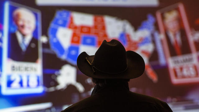 A man watching election night results on TV in 2020 