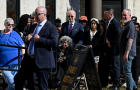 President Biden helps a woman in a wheelchair as he arrives to vote in the 2024 presidential election, in New Castle, Delaware, Oct. 28, 2024. 