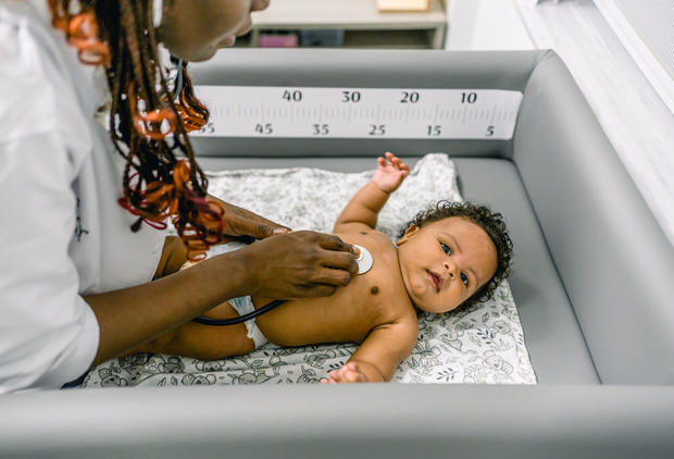 Pediatrician examining baby 