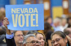 Man holds "Nevada Vote!" sign at a campaign rally 