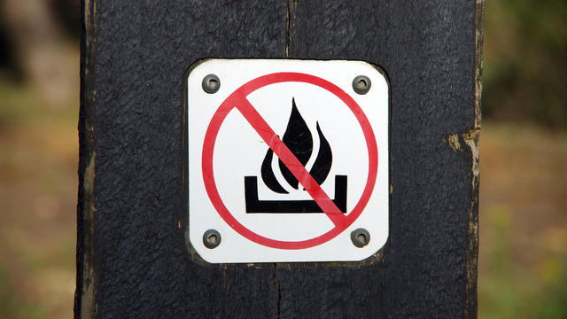 'No fires' sign on a wooden post in Canberra Nature Park, Canberra, Australian Capital Territory, Australia 