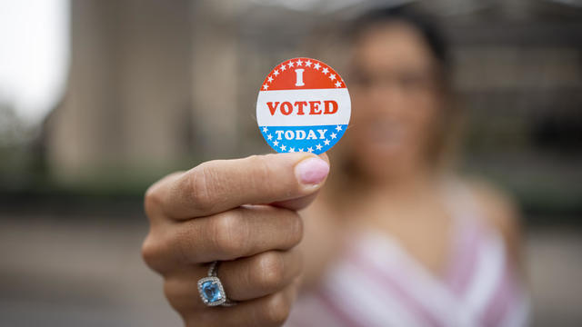 Young Hispanic Woman with I voted Sticker 