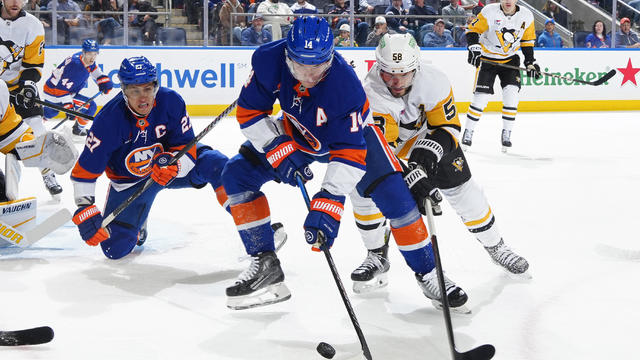 Bo Horvat #14 of the New York Islanders is defended by Kris Letang #58 of the Pittsburgh Penguins during the first period at UBS Arena on November 05, 2024 in Elmont, New York. 