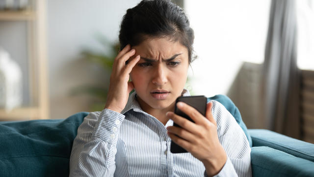 Frustrated girl feel stressed with cellphone problems 