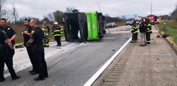 Crews work at the scene of an overturned bus carrying passengers on Interstate 490 west of Rochester, New York on November 7, 2024.