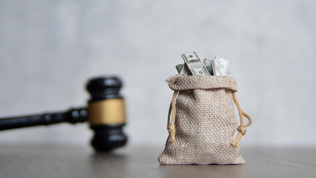 Closeup image bag of money and judge gavel. 